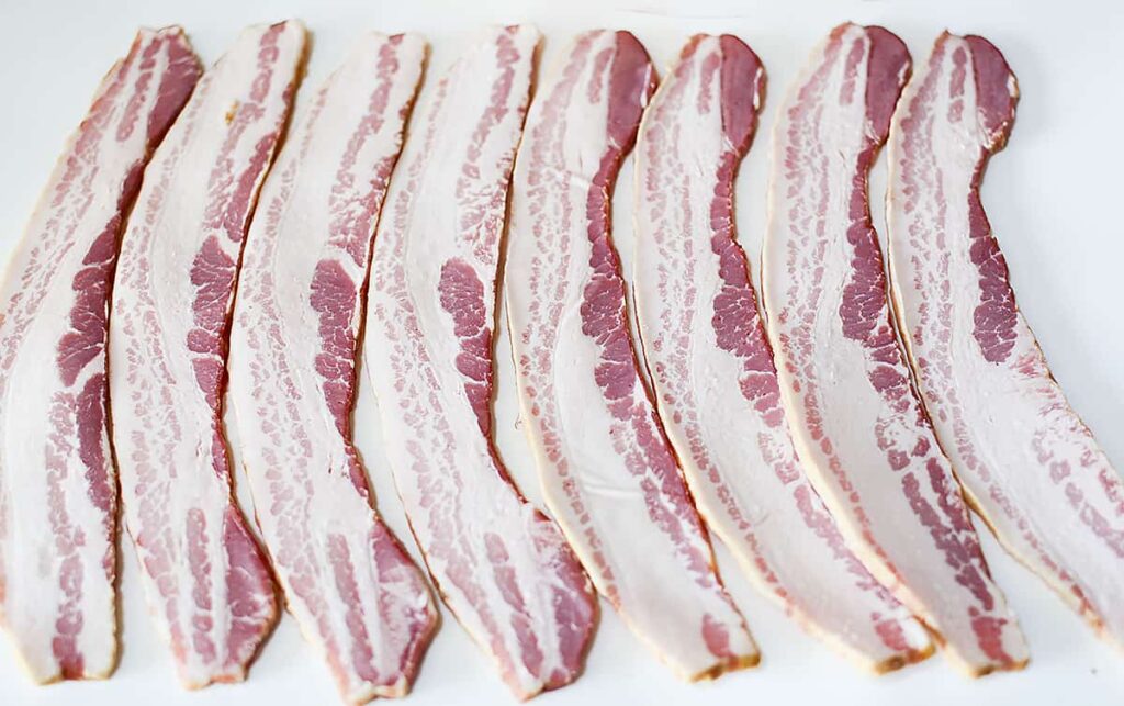 8 slices of bacon laid out horizontally next to eachother.