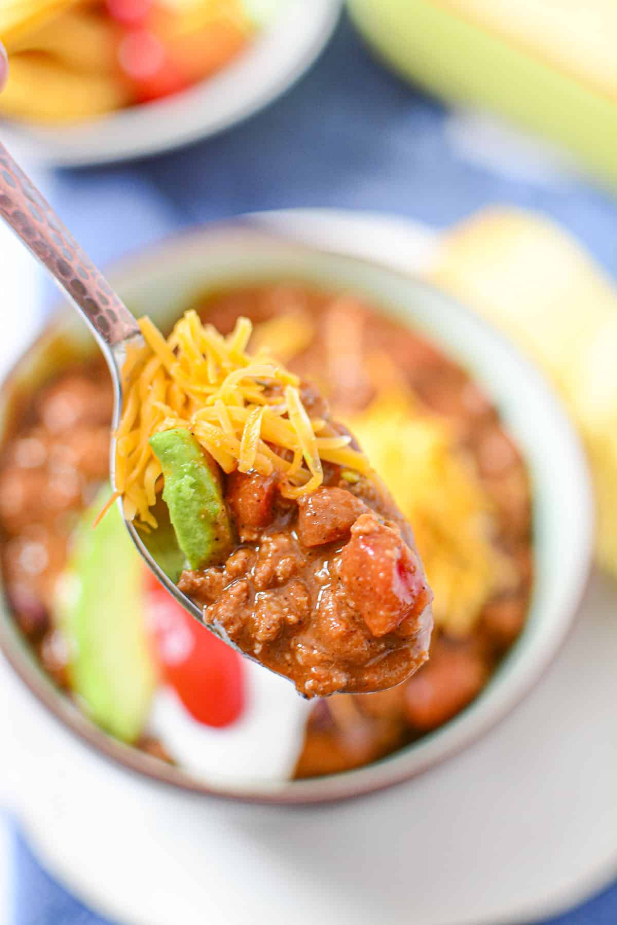 A mouthful of delicious chili on a spoon.