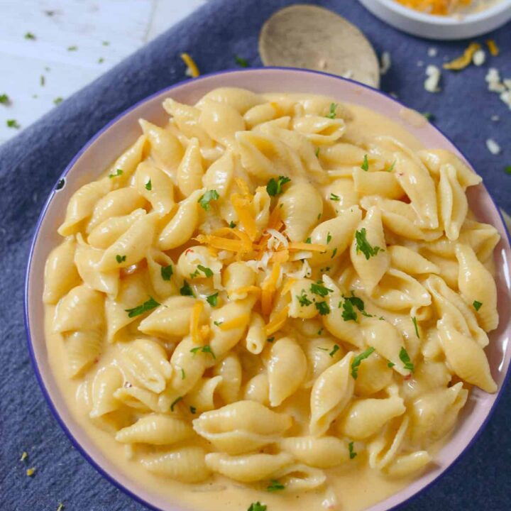 Creamy mac and cheese on a blue napkin.