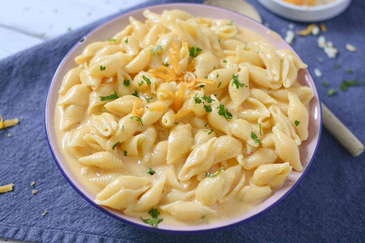 Macaroni with cheese sauce in a bowl.