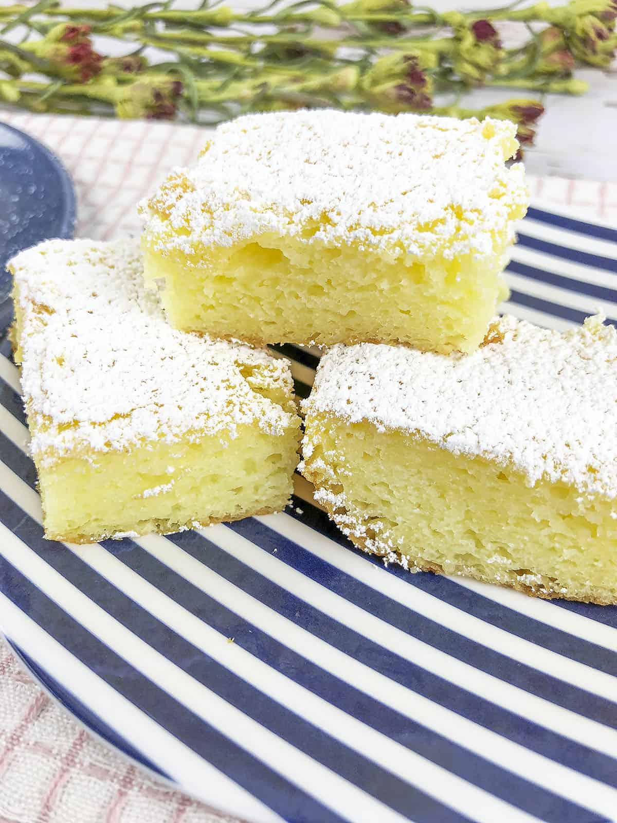 Three lemon bars stacked on top each other.