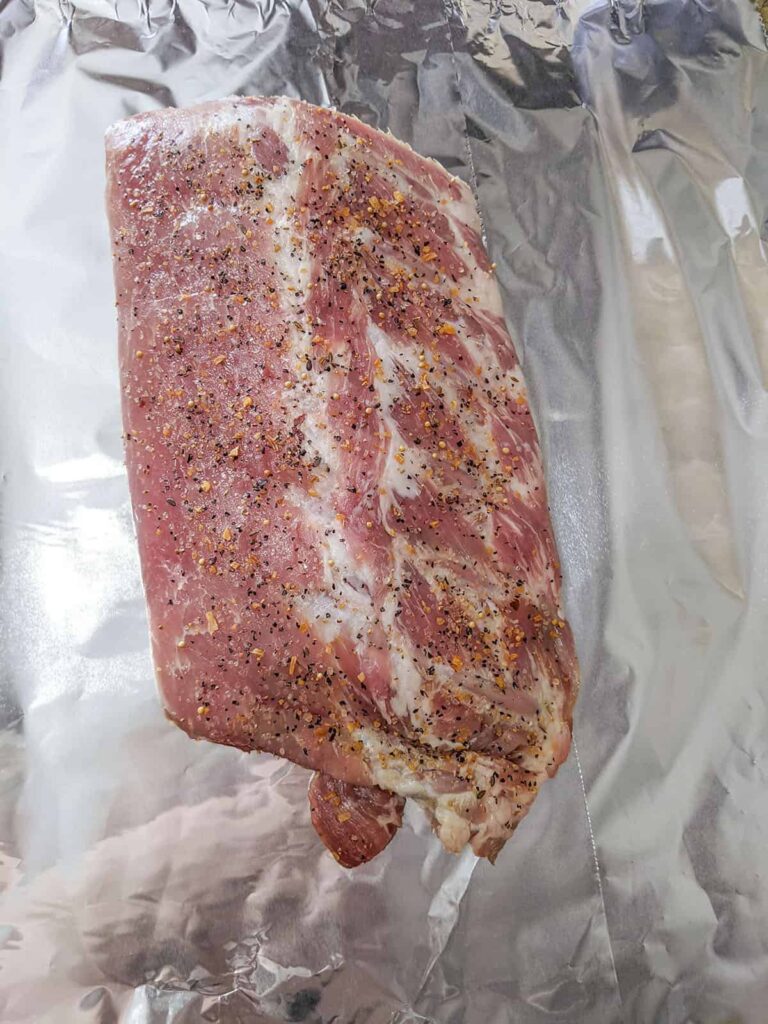 A small rack of ribs on aluminum foil.