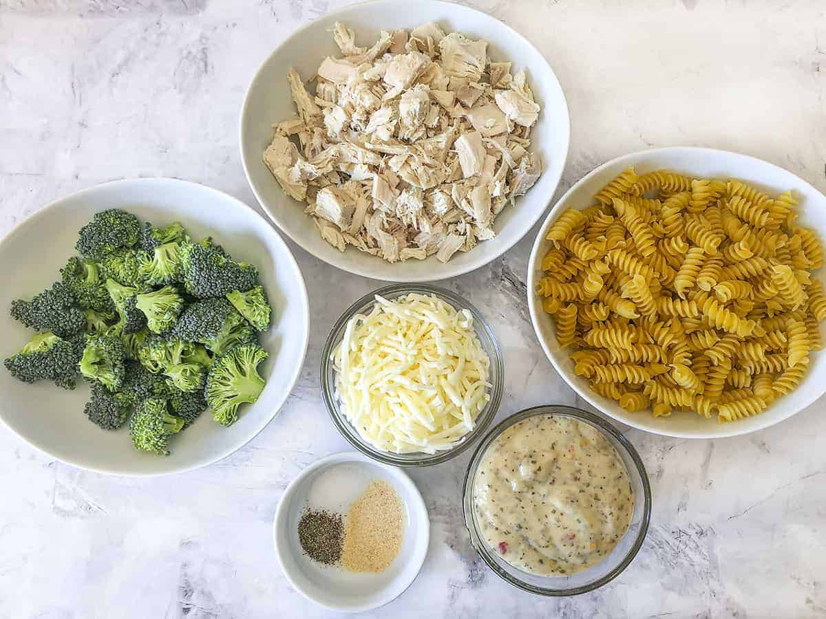 Ingredients in bowls that are needed for making this chicken broccoli casserole. 
