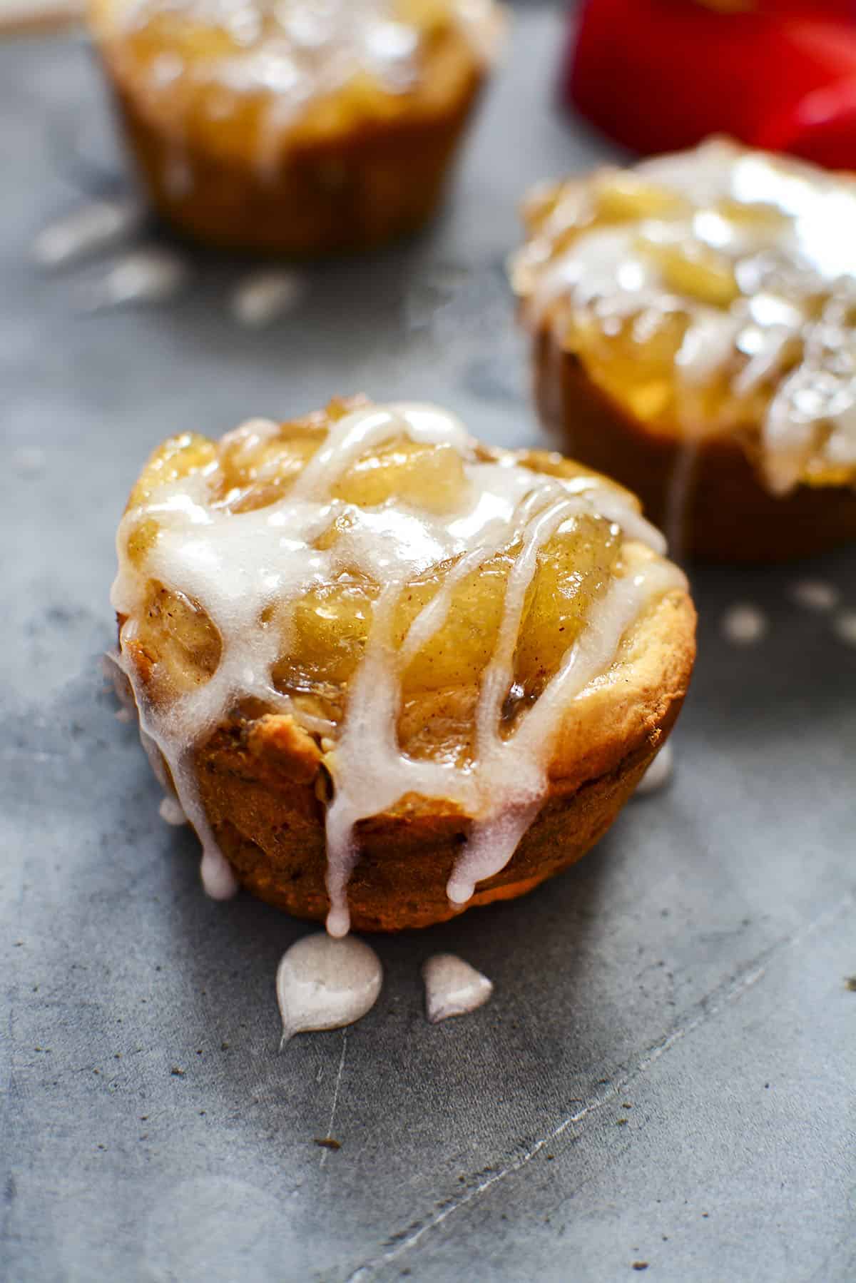 A cinnamon apple pie cup with a sugar glaze drizzled over the top. 