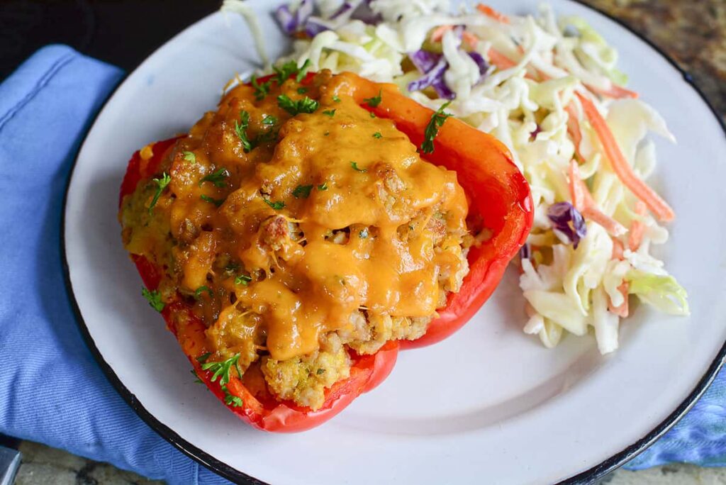 A ground chicken stuffed pepper on a white plate.