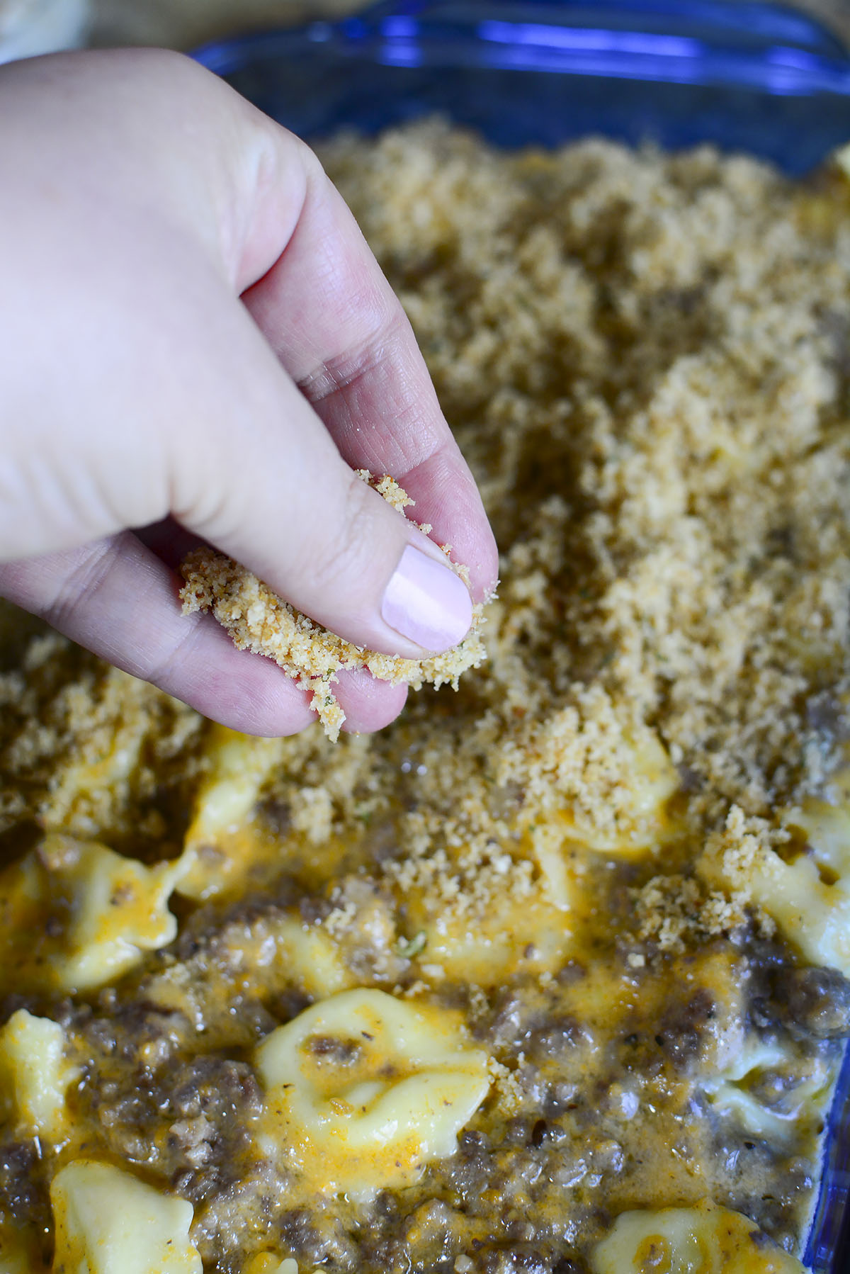 Sprinkling breadcrumbs over top the casserole.
