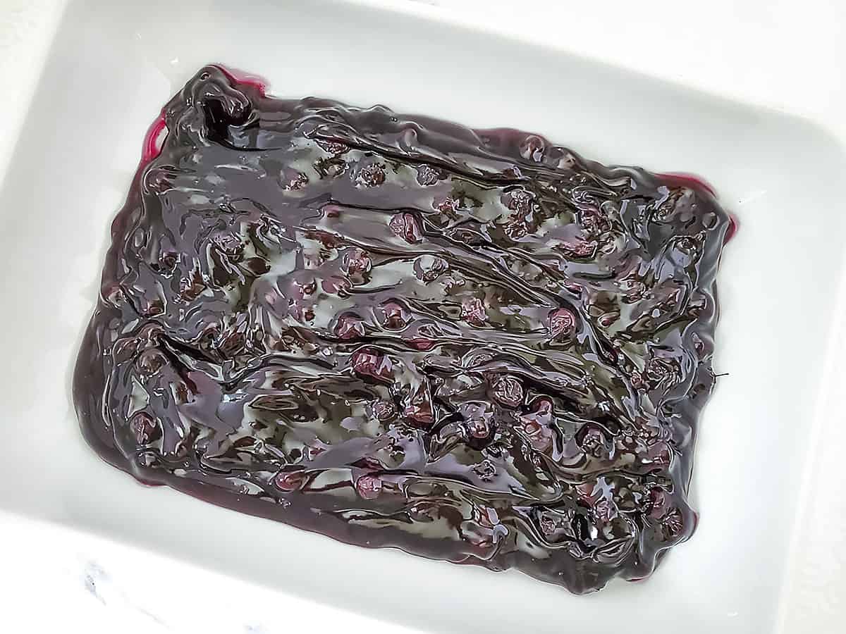 Blueberry pie filling spread in the bottom of a 9 x 13 baking dish.