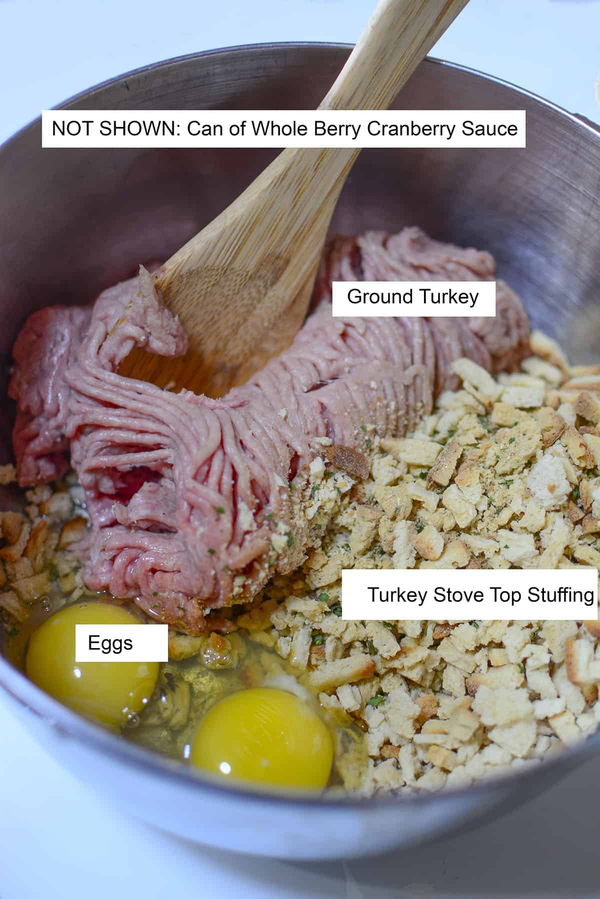The ingredients to make the meatloaf featured in a bowl. Ground turkey, stove top stuffing and two eggs.