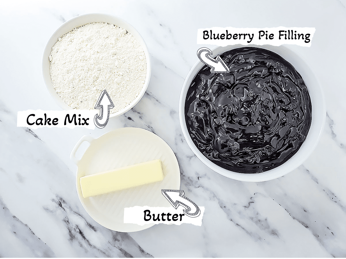 Ingredients for a 3 Ingredient Blueberry Dump Cake which are cake mix, blueberry pie filling and butter.