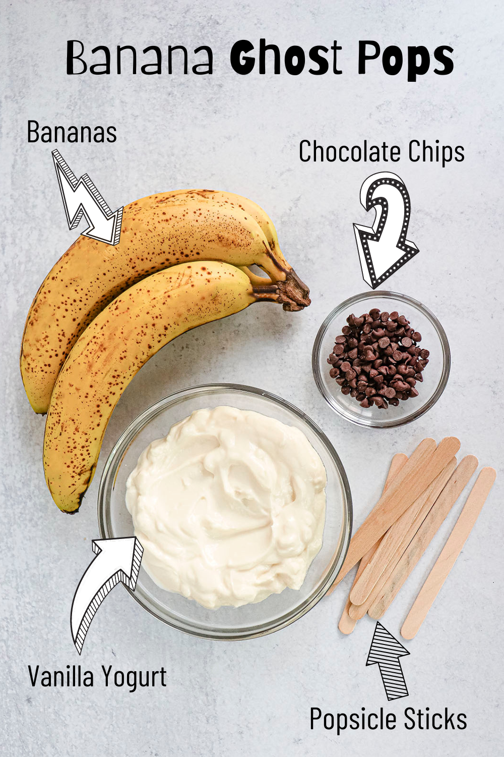 The three ingredients needed for this recipe. Bananas, chocolate chips and vanilla yogurt. There are popsicle sticks on the bottom right.