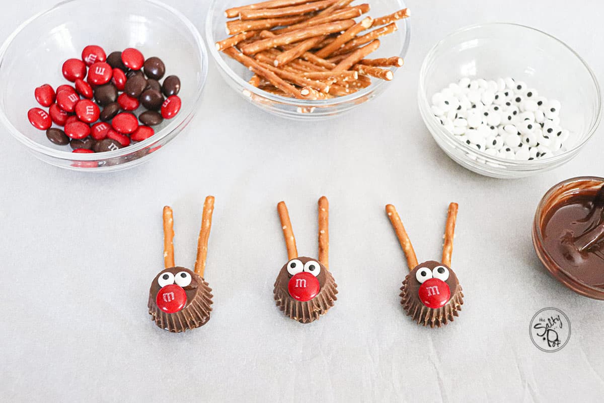 Three chocolate rudolphs with red noses and candy eyes.