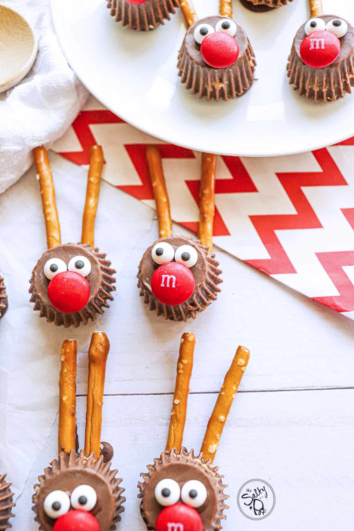 Four handmade chocolate rudolph candies on a white board. 
