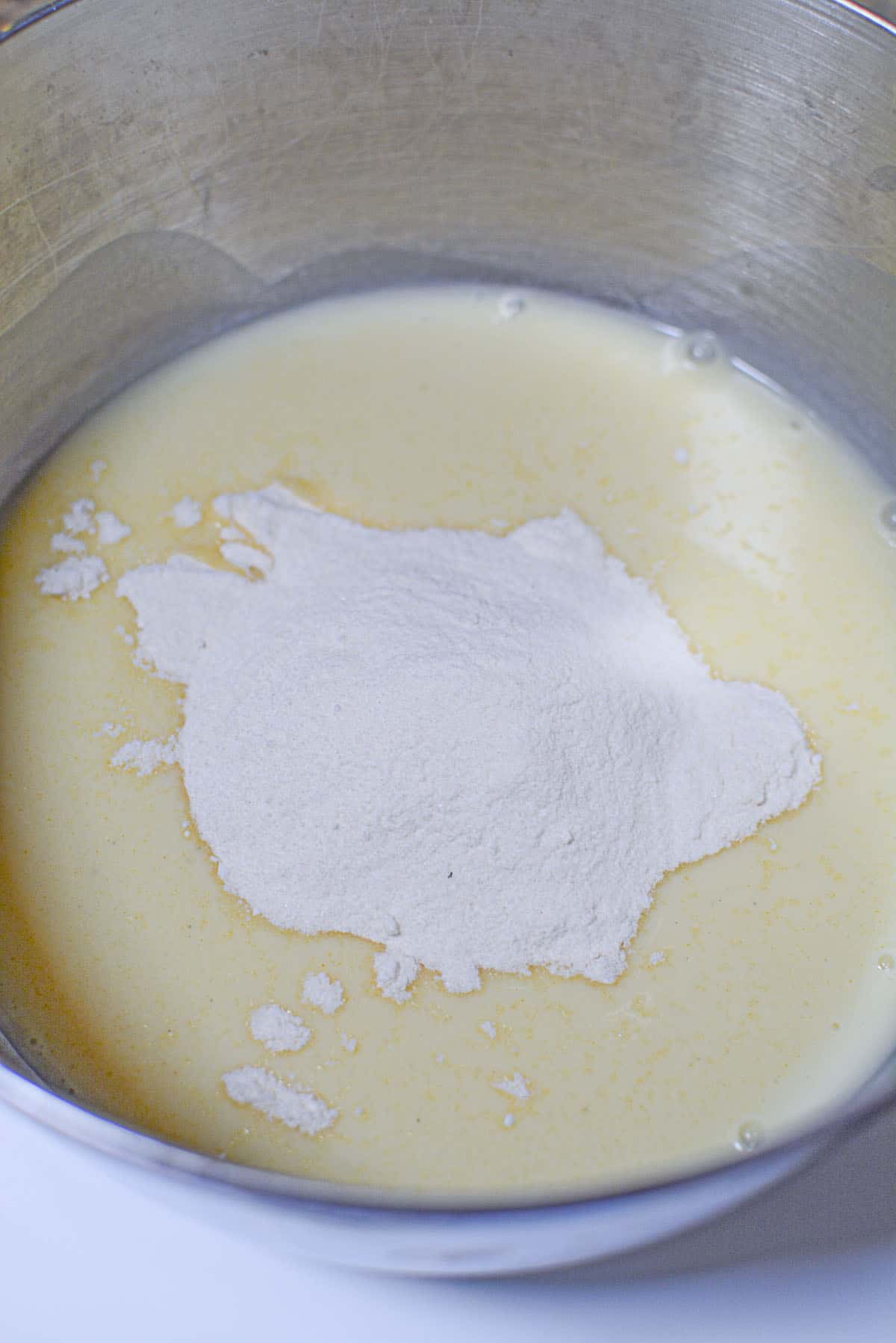The Instant Pudding is added to the cold eggnog.