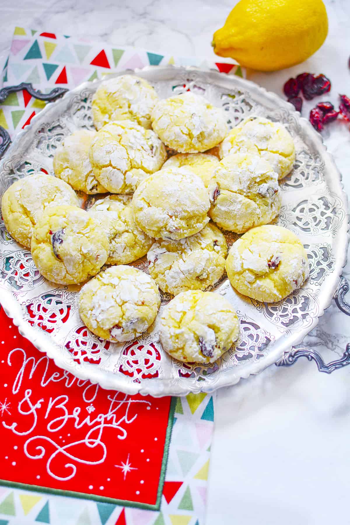 Festive cookies on a serving plate with a Christmas napkin underneath.