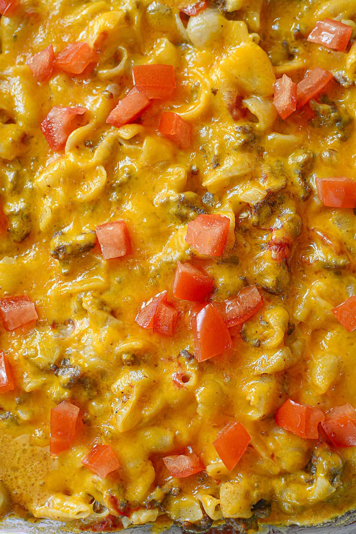 A close up of the casserole with cheese on top.