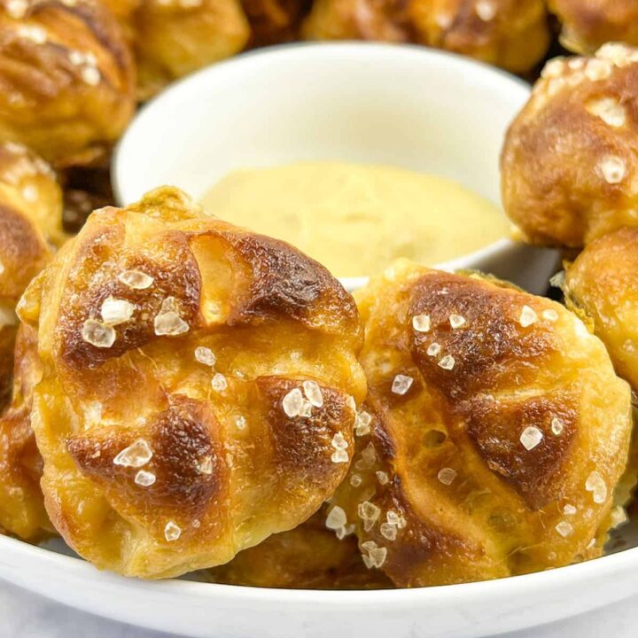 Easy pretzel knots surrounding a bowl of cheese sauce.
