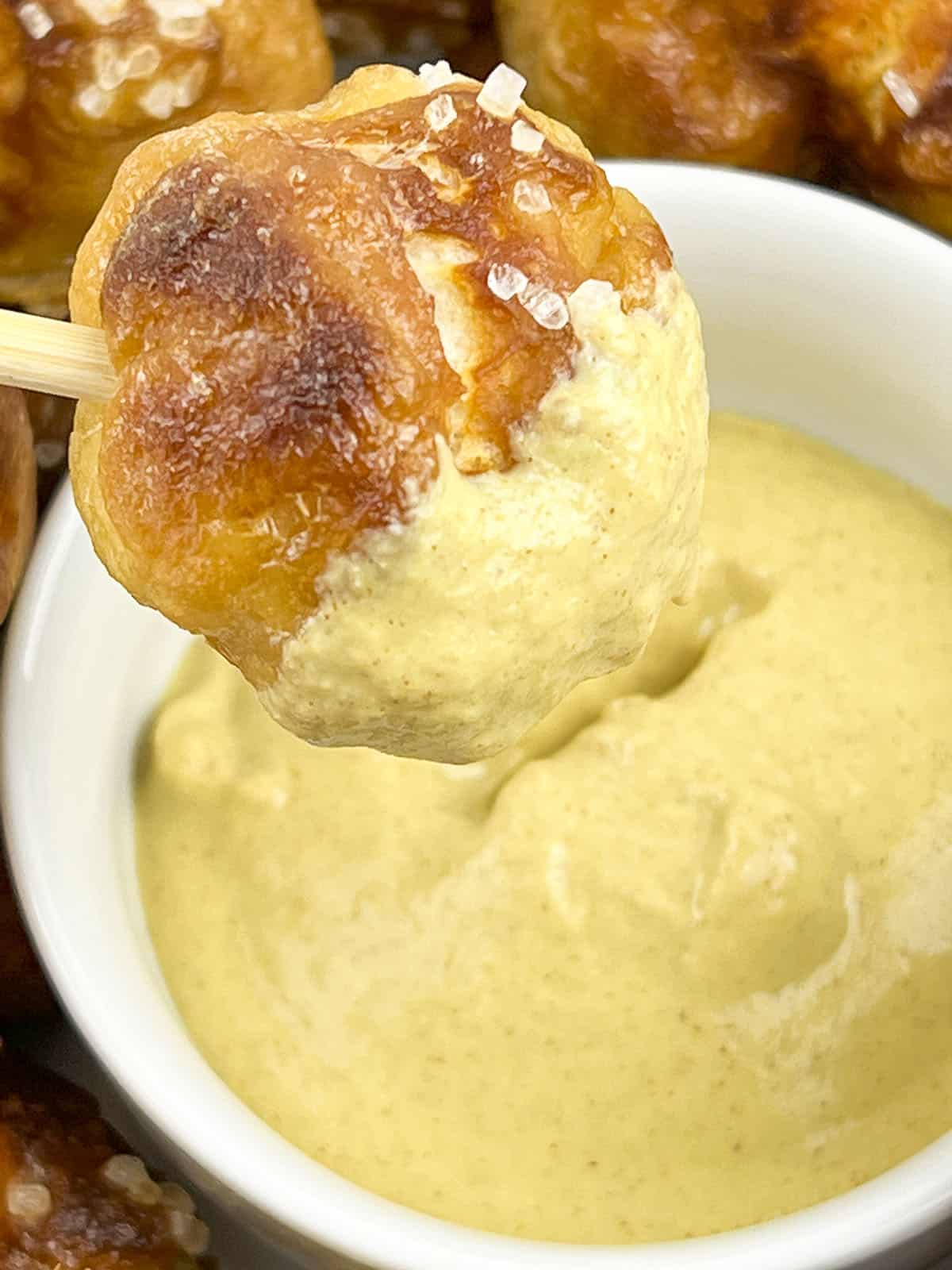 Dipping the pretzel knots in cheese sauce