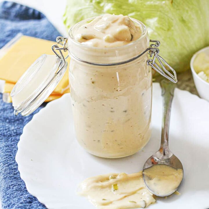 Mac sauce in a jar on a white plate.