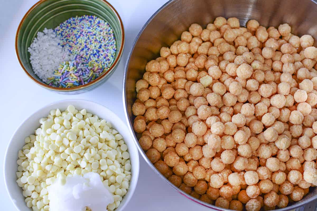 Ingredients for the snowman poop. Corn pops, white chocolate chips, coconut oil and sprinkles.