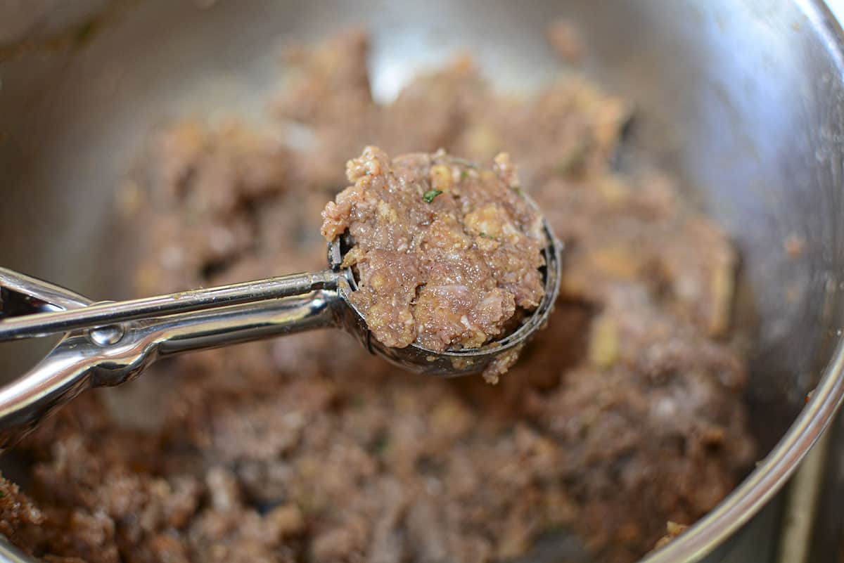 Meatloaf mixture scooped into a ball.