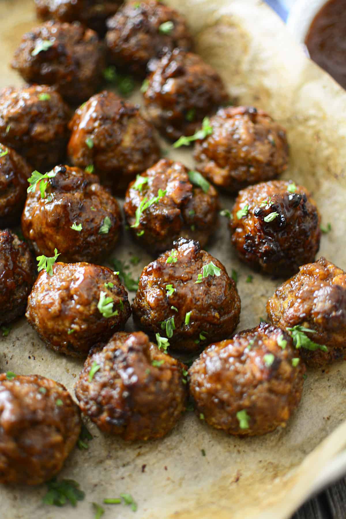 Freshly baked BBQ meatballs on a baking tray.