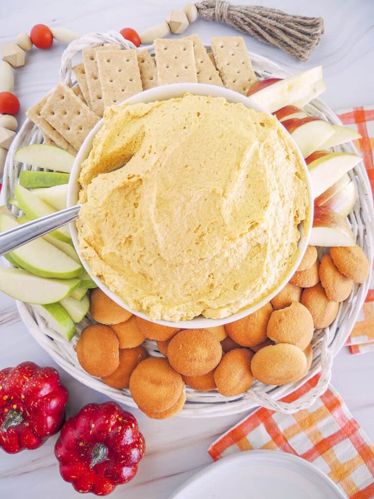 3 Ingredient Pumpkin Fluff in a bowl surrounded with dipping things like apples, crackers and cookies. 