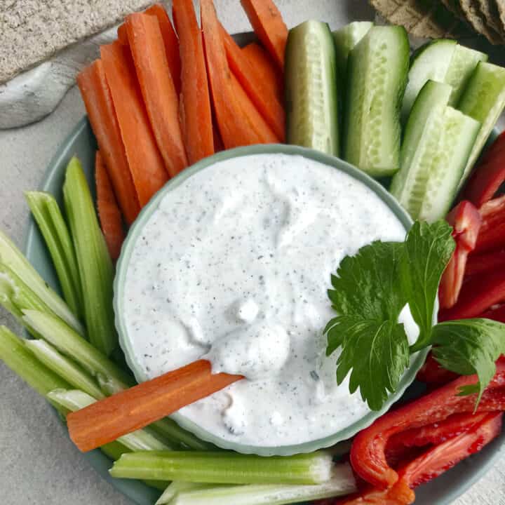 Two Ingredient Ranch Dip Square image. Veggies surround the bowl of dip.
