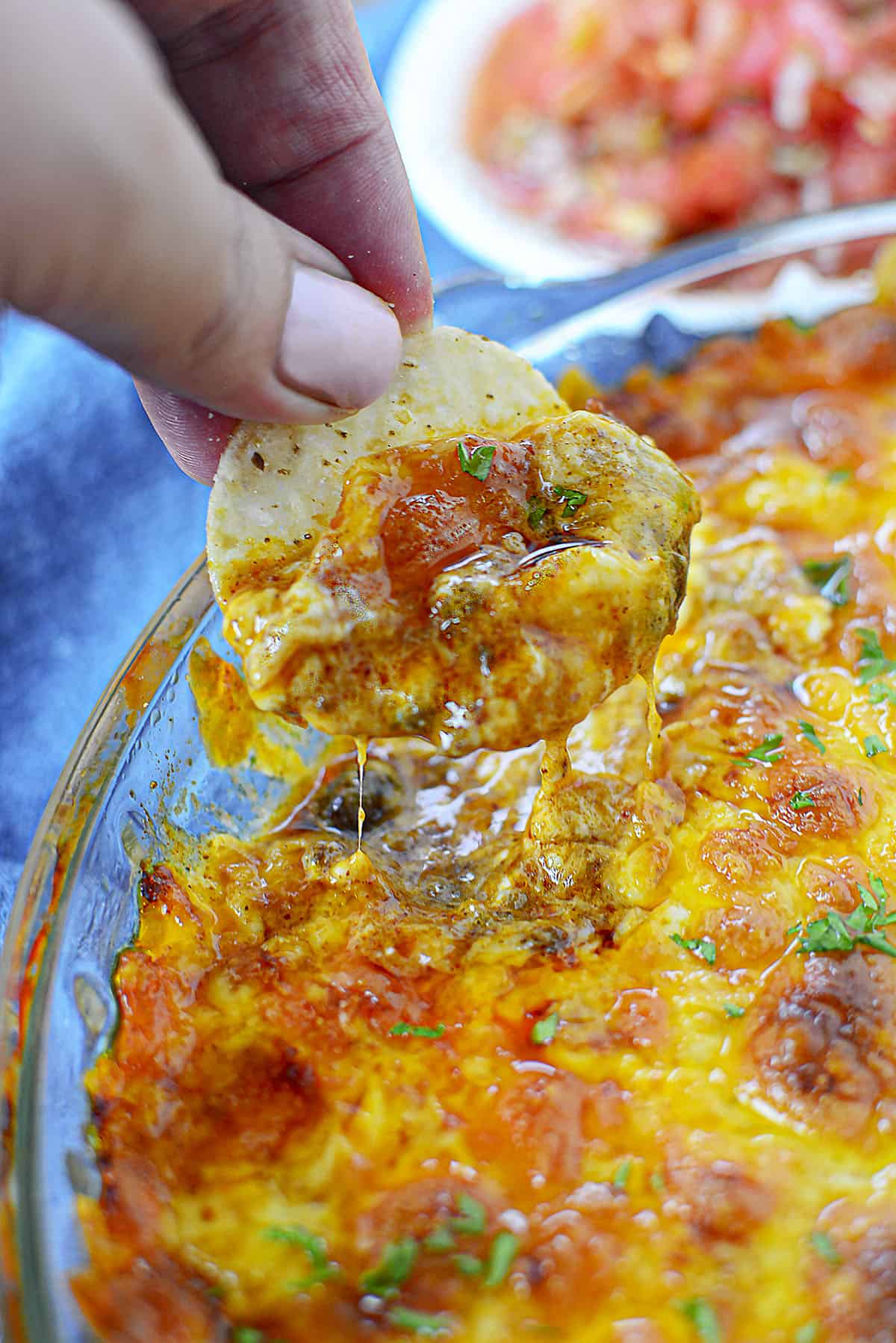 Dipping a tortilla into the baked chili cheese dip. 