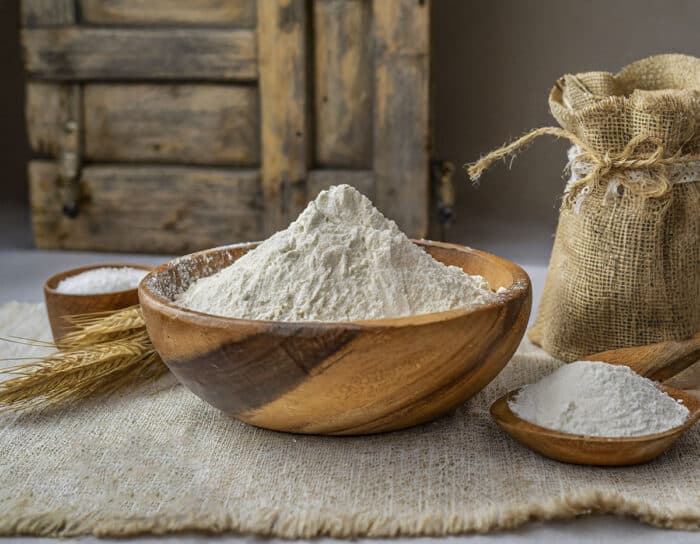 3 ingredient self raising flour square image. A bowl of self rising flour surrounded by ingredients to make it.