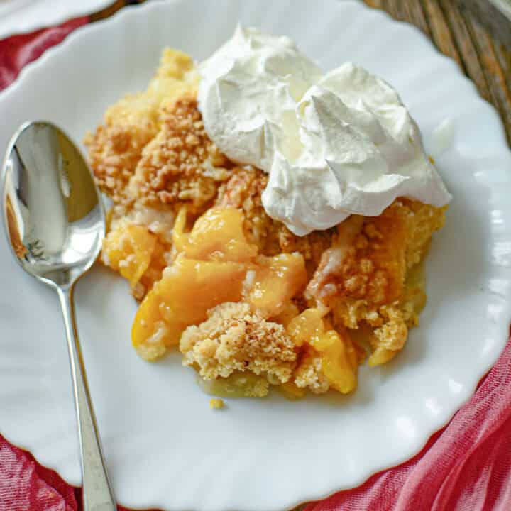 Peach cobbler on a white plate.