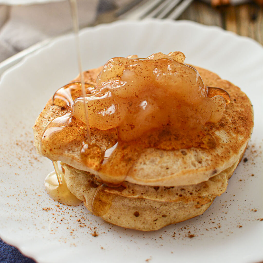 2 ingredient apple cinnamon oat pancakes on a white plate.