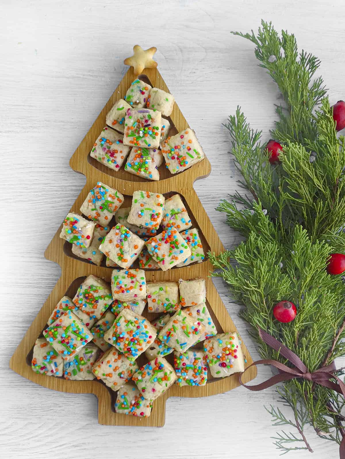 Elf cookie bites in a decorative wooden tray. 