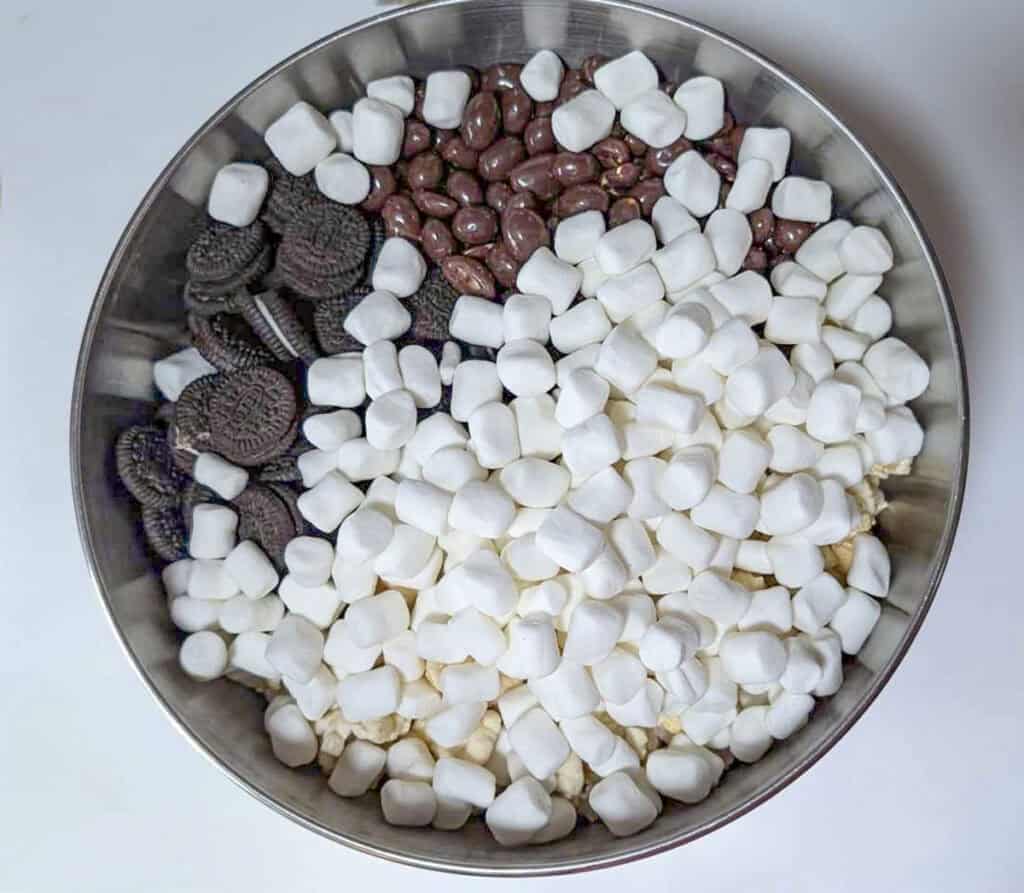 Mini marshmallows are added to the snack mix.