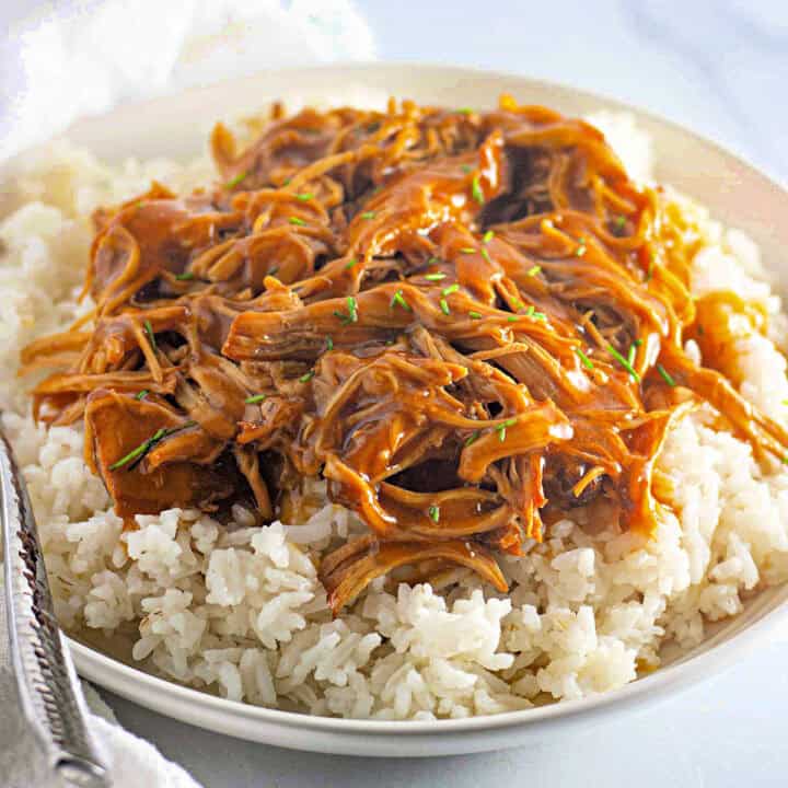 Honey Garlic Chicken Bowl with a fork on the left, square image.