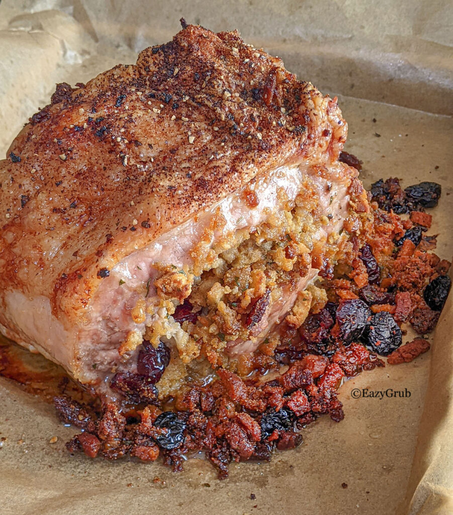 3 Ingredient cranberry stuffed pork loin roast on parchment paper lined baking sheet.