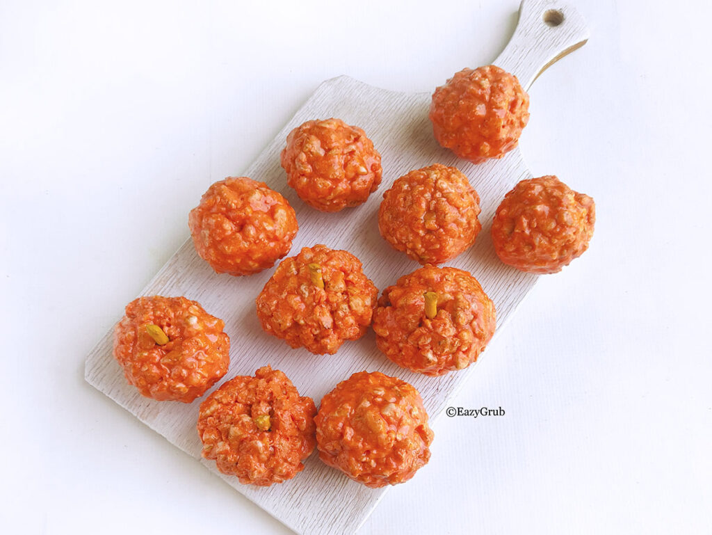 The rice and marshmallow mixture formed to make pumpkin shapes with a pretzel stuck into the center of one.