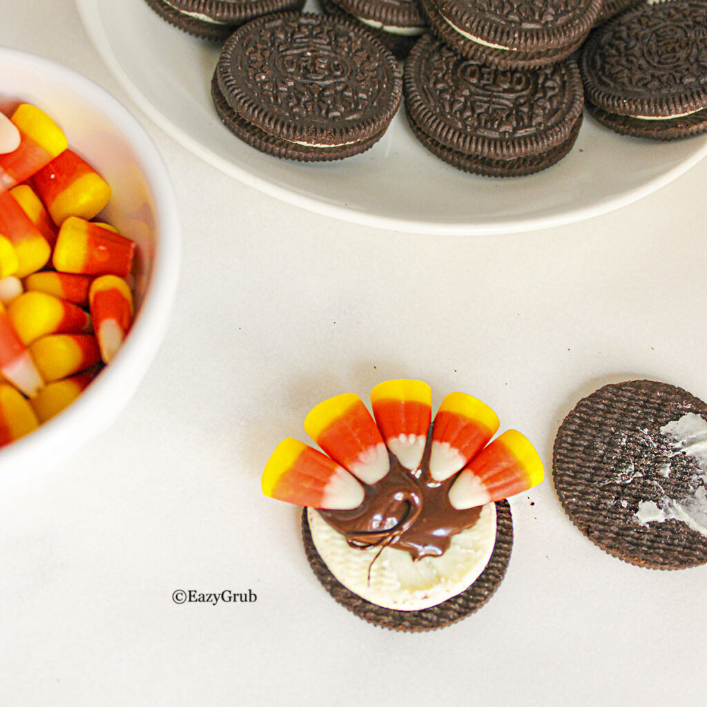 5 pieces of candy corn places along the border of the cookie.