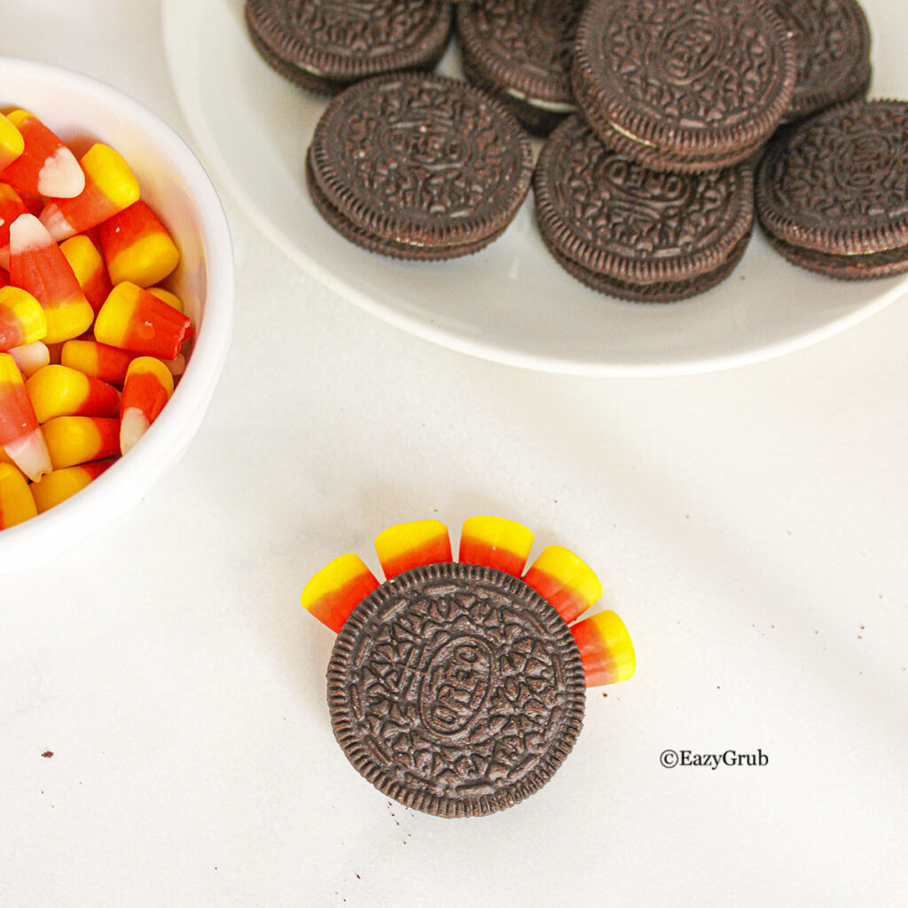 The top part of the cookie placed on top. Other cookies on the top right, candy corn on the left.