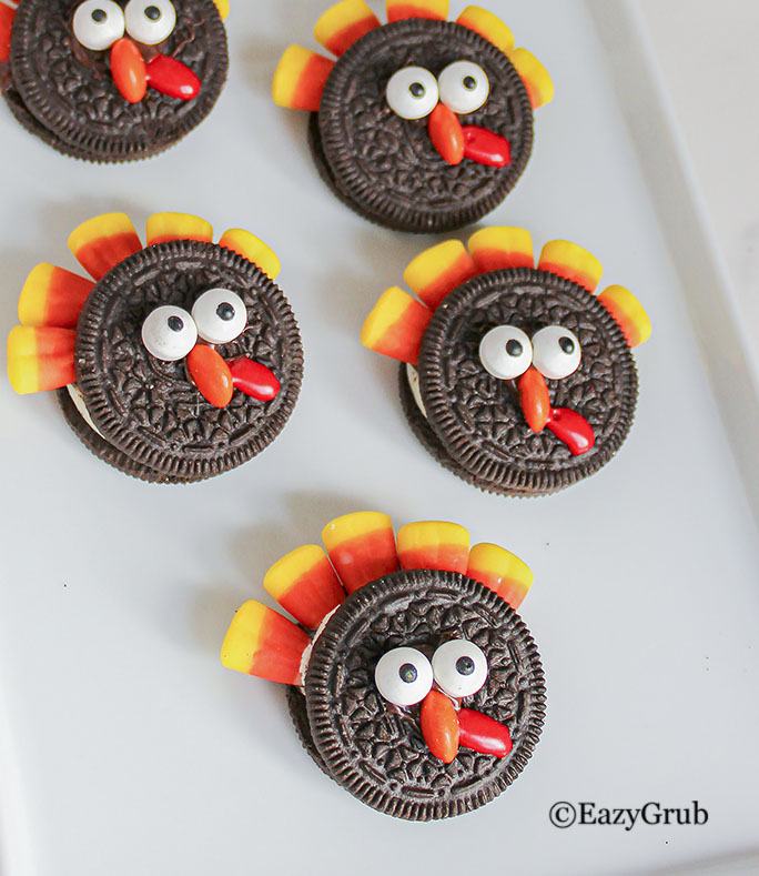 5 thanksgiving oreo turkeys on a white plate.