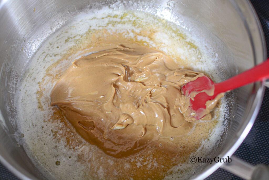 Peanut butter melted in the butter in a pot.