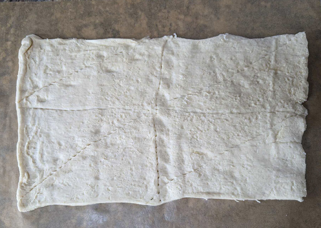 Crescent dough unrolled on a table.