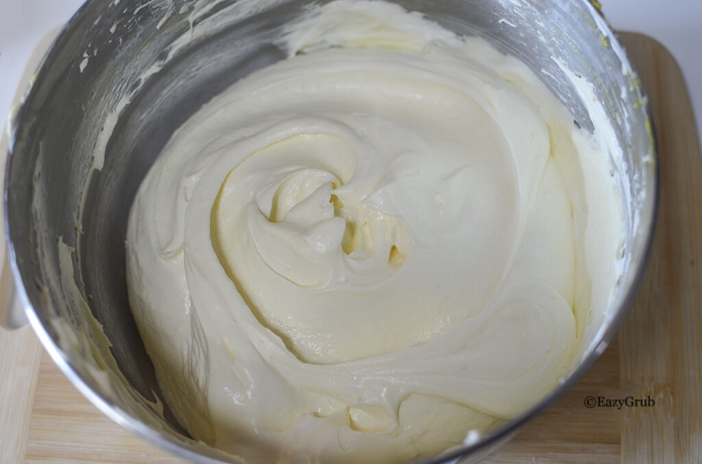 Folding Cool Whip into lemon pudding until smooth and fluffy.