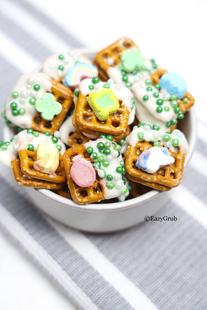 Chocolate marshmallow pretzel snacks in a white bowl.