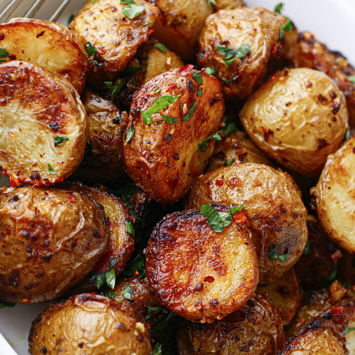 Spicy roasted potatoes in a bowl, close up.