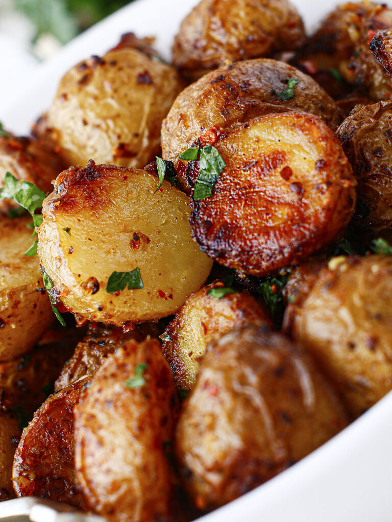 An extreme close up of crispy baby potatoes.
