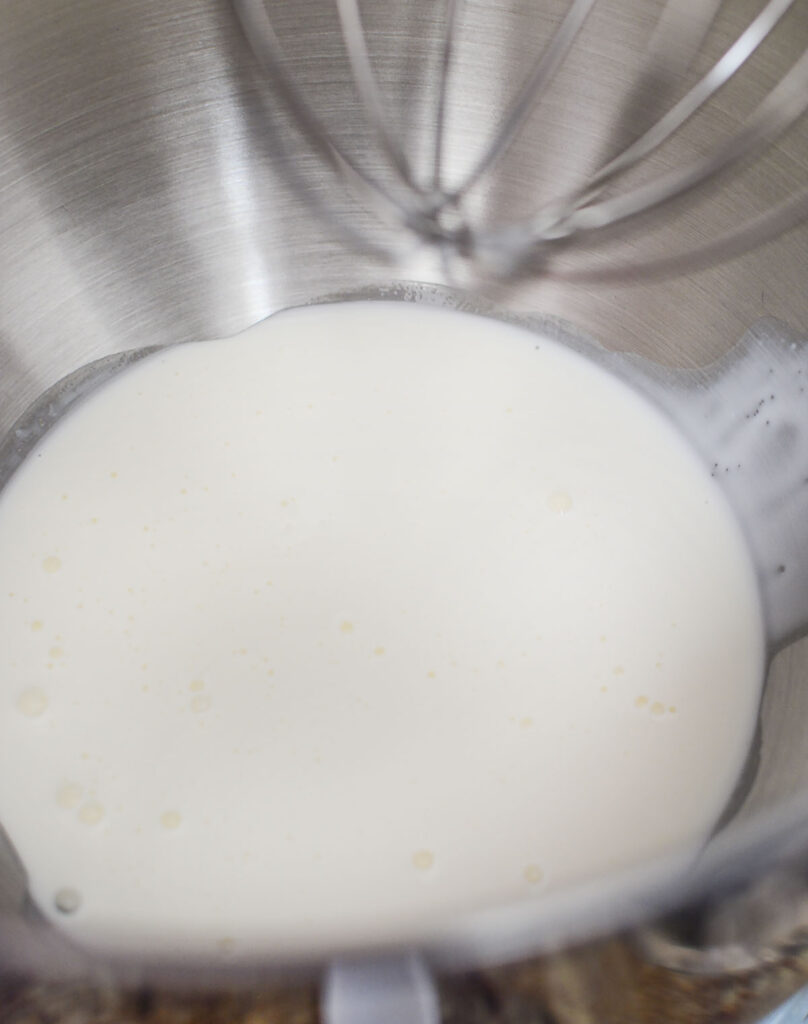 Heavy whipping cream in a silver bowl. 