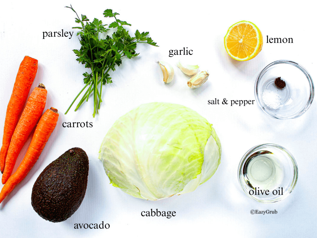 carrots, parsley, garlic, half-sliced lemon, cabbage, 3 garlic cloves, olive oil in bowl, salt & pepper in bowl, avocado 