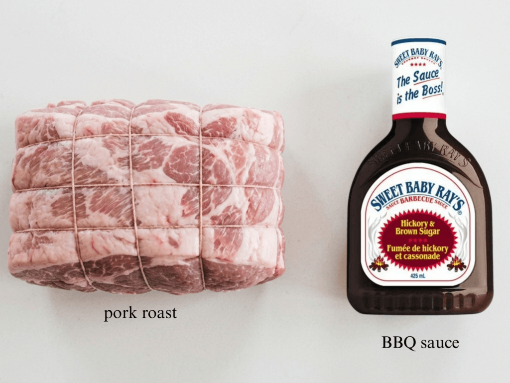 A side-by-side shot of the two required ingredients on a white surface. On the left is a large, raw, netted pork roast and on the right is a bottle of Sweet Baby Ray’s Hickory & Brown Sugar BBQ sauce.