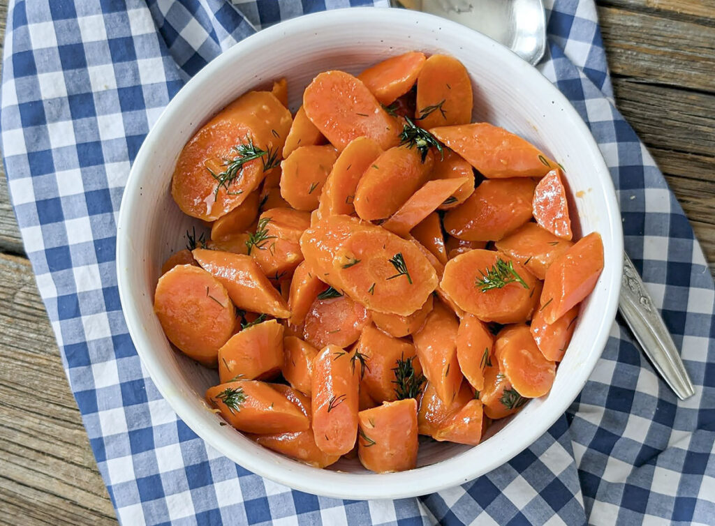 Dilled carrots in a white bowl.