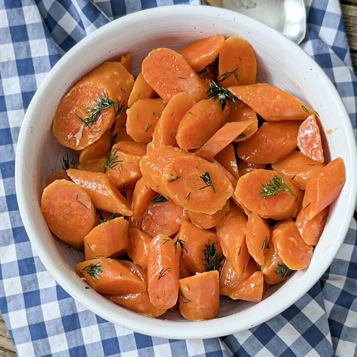 Dilled carrots in a white bowl.